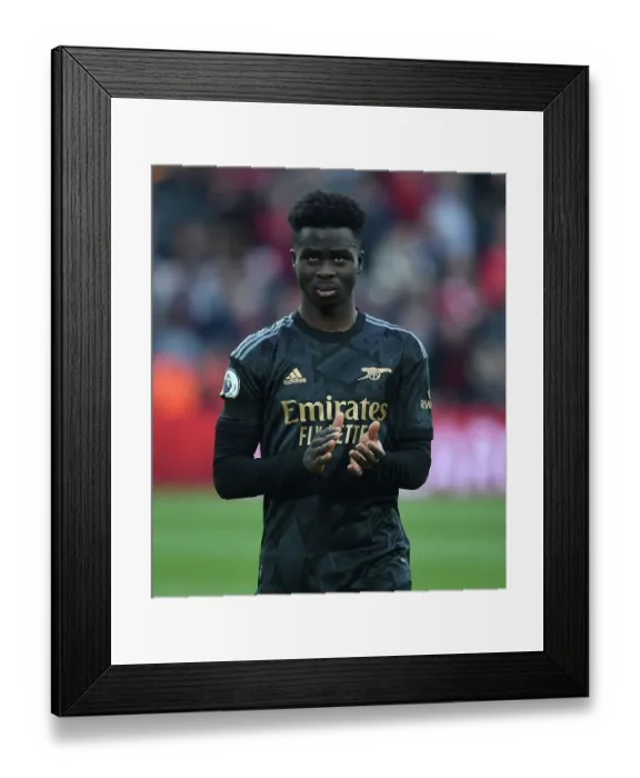 Framed Print : Bukayo Saka Salutes Arsenal Fans: Triumphant Moment at Anfield After Intense Liverpool Clash (Premier League 2022-23)