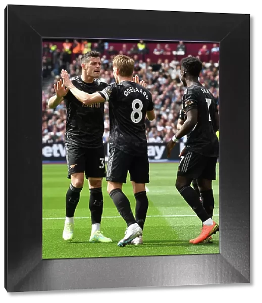 Arsenal's Martin Odegaard and Bukayo Saka Celebrate Epic Goals in Thrilling Premier League Showdown vs West Ham United, London 2023