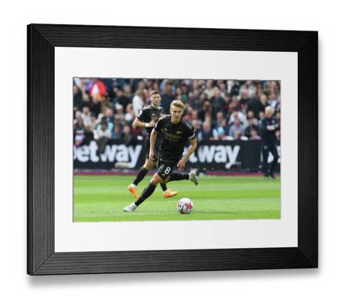 Framed Print : Martin Odegaard Charges Forward: West Ham United vs. Arsenal FC, Premier League 2022-23 Framed Print : Martin Odegaard Charges Forward: West Ham United vs. Arsenal FC, Premier League 2022-23