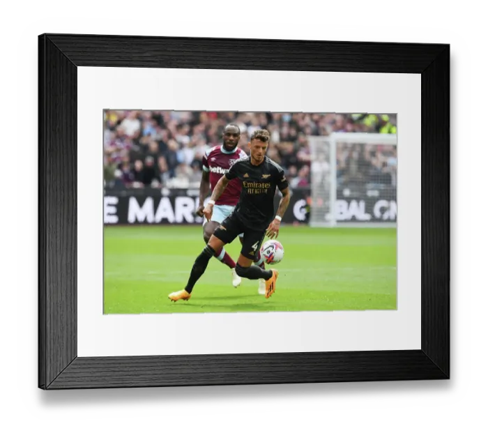 Framed Print : Arsenal's Ben White Sprints Past West Ham Defenders in Premier League Clash