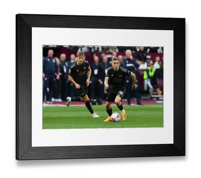 Framed Print : Arsenal's Trossard Sprints Past West Ham Defense in Premier League Clash Framed Print : Arsenal's Trossard Sprints Past West Ham Defense in Premier League Clash