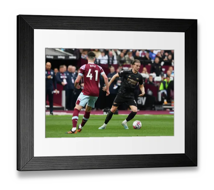 Framed Print : Arsenal's Rob Holding Charges Forward in Premier League Clash Against West Ham United Framed Print : Arsenal's Rob Holding Charges Forward in Premier League Clash Against West Ham United