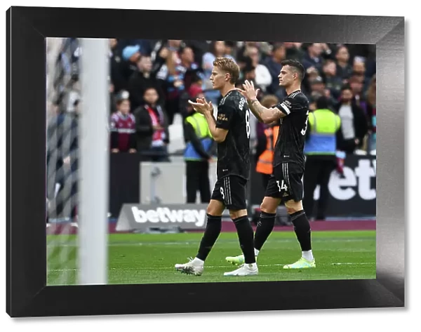 Arsenal Players Granit Xhaka and Martin Odegaard Celebrate with Fans after West Ham Victory, 2022-23 Premier League