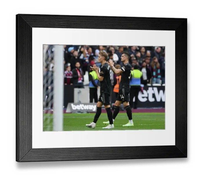 Framed Print : Arsenal Players Granit Xhaka and Martin Odegaard Celebrate with Fans after West Ham Victory, 2022-23 Premier League
