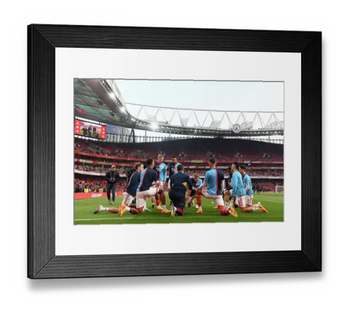 Framed Print : Arsenal FC vs Southampton FC: Premier League Showdown - Arsenal Players Warm Up at Emirates Stadium
