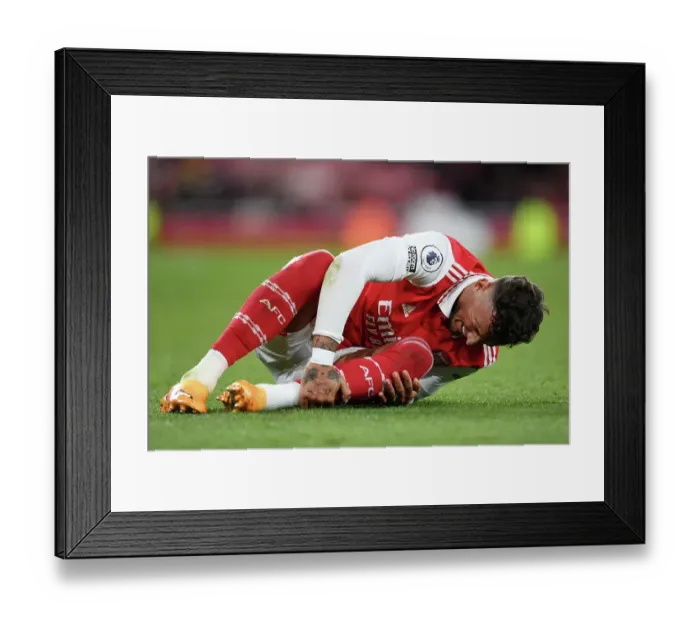 Framed Print : Arsenal's Ben White Clutches Injured Ankle Amidst Intense Arsenal v Chelsea Rivalry (2022-23)