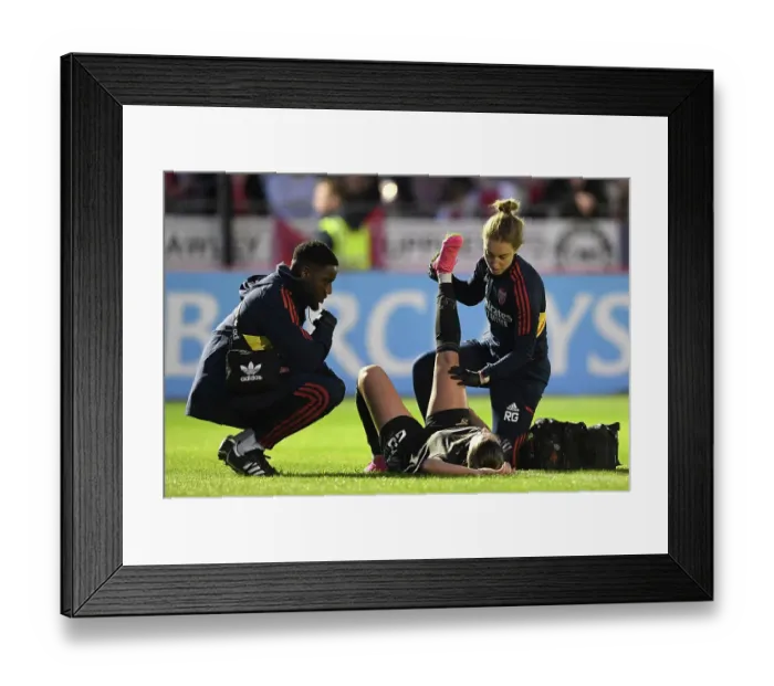 Framed Print : Arsenal Women's Star Gio Queiroz Receives Treatment from Physio during Brighton Match