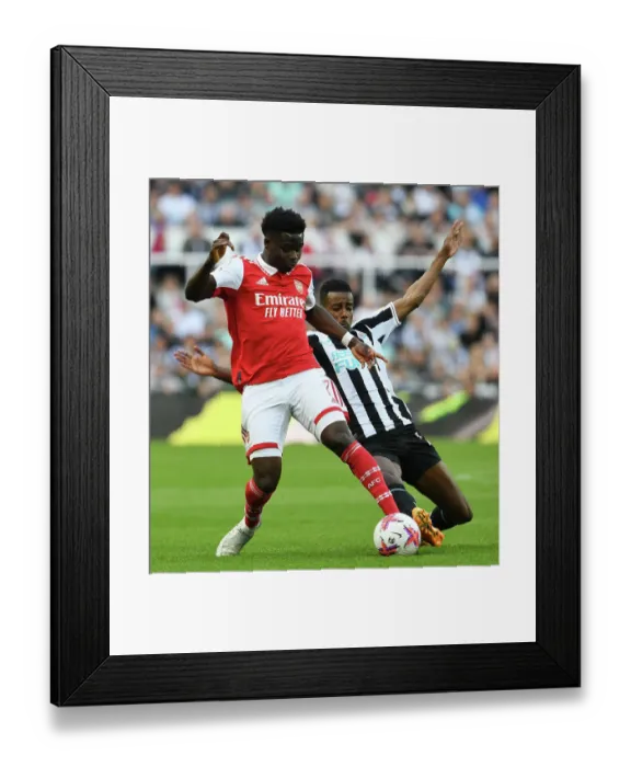 Framed Print : Saka vs. Isak: A Wingers Clash at St. James Park - Arsenal vs. Newcastle United (2022-23) Framed Print : Saka vs. Isak: A Wingers Clash at St. James Park - Arsenal vs. Newcastle United (2022-23)