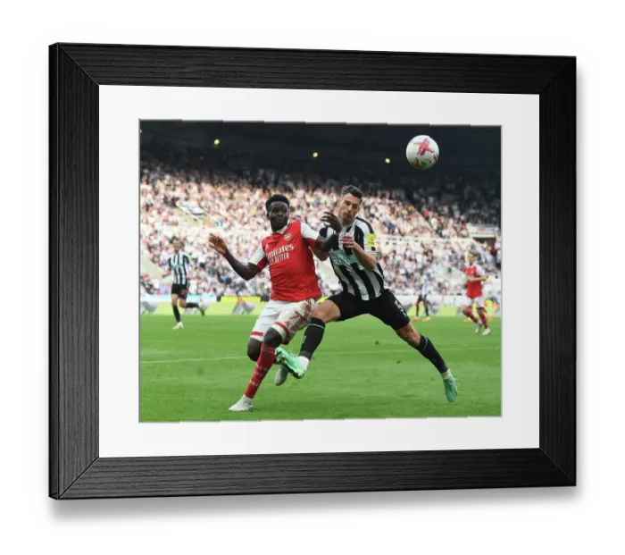 Framed Print : Bukayo Saka vs Fabian Schar: Intense Battle at St. James Park - Arsenal vs Newcastle, Premier League 2022-23
