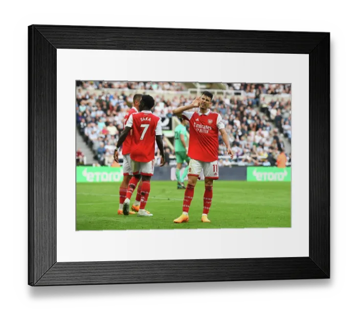 Framed Print : Martinelli's Own Goal Seces Victory for Arsenal over Newcastle
