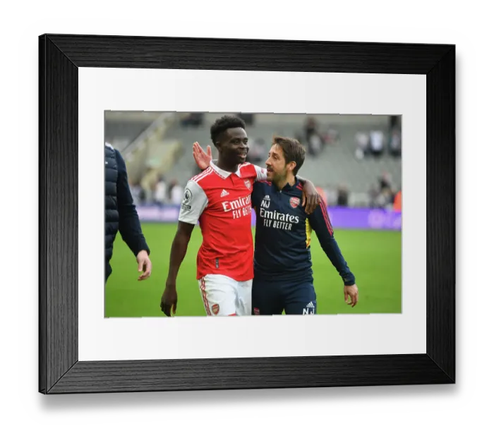 Framed Print : Saka's Celebration: Arsenal Secure Victory over Newcastle United in Premier League Thriller