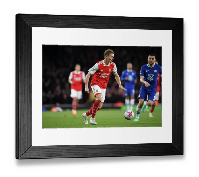 Framed Print : Arsenal's Martin Odegaard Charges Forward Against Chelsea in Premier League Showdown (2022-23) Framed Print : Arsenal's Martin Odegaard Charges Forward Against Chelsea in Premier League Showdown (2022-23)