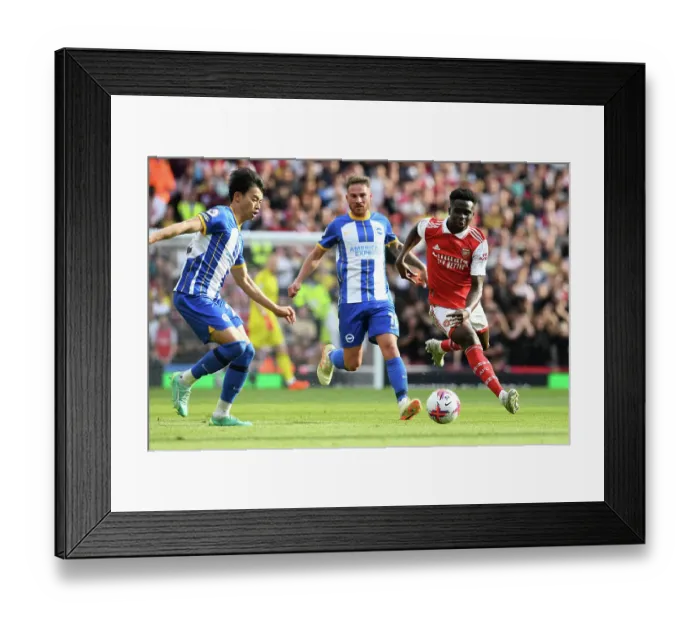 Framed Print : Arsenal's Bukayo Saka Drives Past Brighton Defenders in 2022-23 Premier League Clash