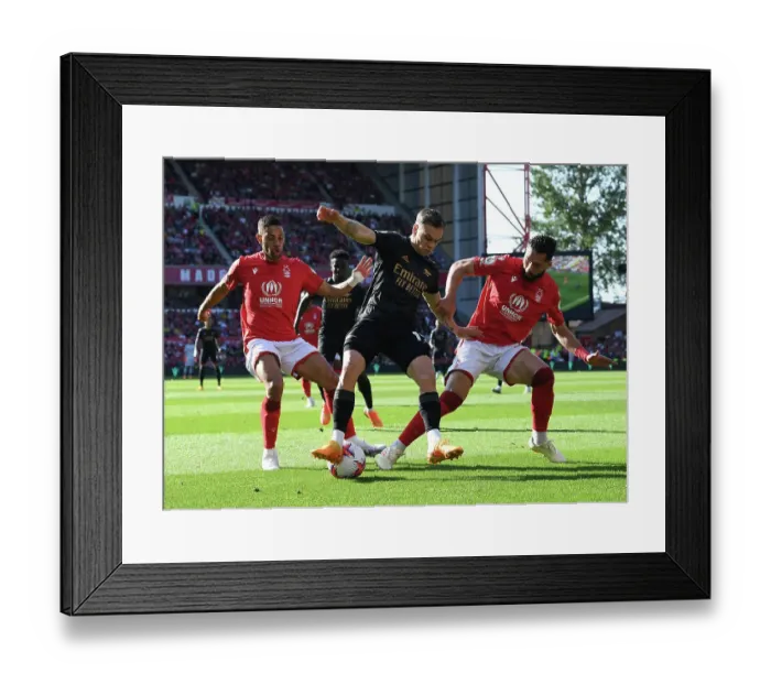 Framed Print : Arsenal's Trossard Faces Off Against Forest's Defense in Premier League Clash