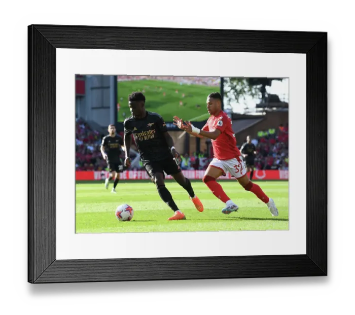 Framed Print : Saka vs. Lodi: Intense Battle in Nottingham Forest vs. Arsenal Premier League Clash Framed Print : Saka vs. Lodi: Intense Battle in Nottingham Forest vs. Arsenal Premier League Clash