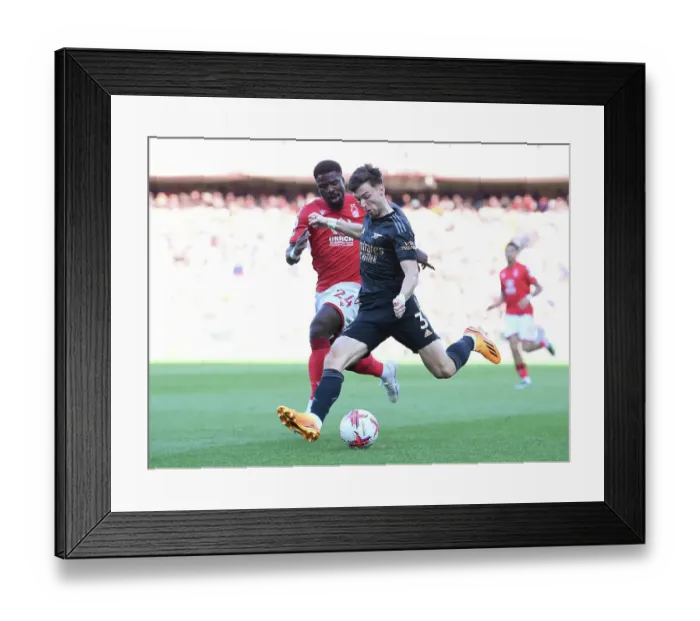 Framed Print : Arsenal's Kieran Tierney Clashes with Nottingham Forest's Serge Aurier in Premier League Showdown
