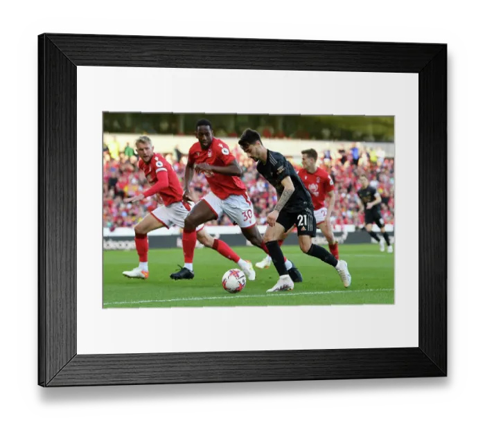 Framed Print : Arsenal's Fabio Vieira Soars Past Nottingham Forest's Willy Boly: Premier League Clash 2022-23 Framed Print : Arsenal's Fabio Vieira Soars Past Nottingham Forest's Willy Boly: Premier League Clash 2022-23