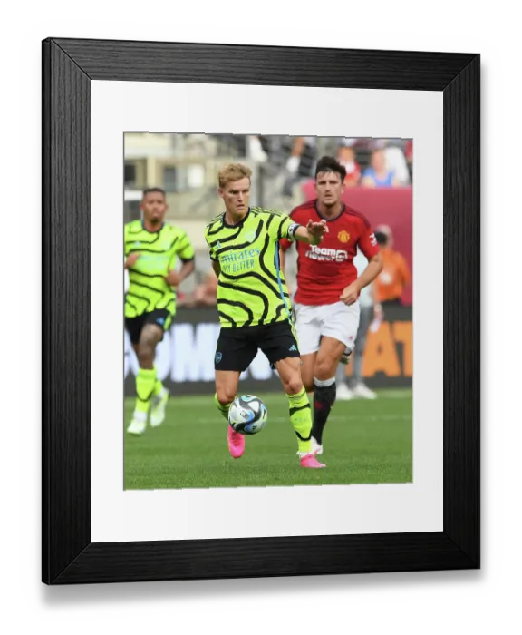 Framed Print : Arsenal's Martin Odegaard Shines: Outperforming Manchester United at MetLife Stadium (2023)