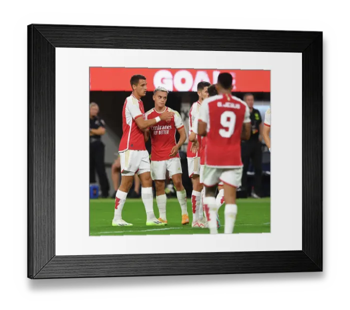 Framed Print : Arsenal's Four-Goal Blitz: Trossard & Kiwior Celebrate vs. FC Barcelona (Pre-Season 2023-24)