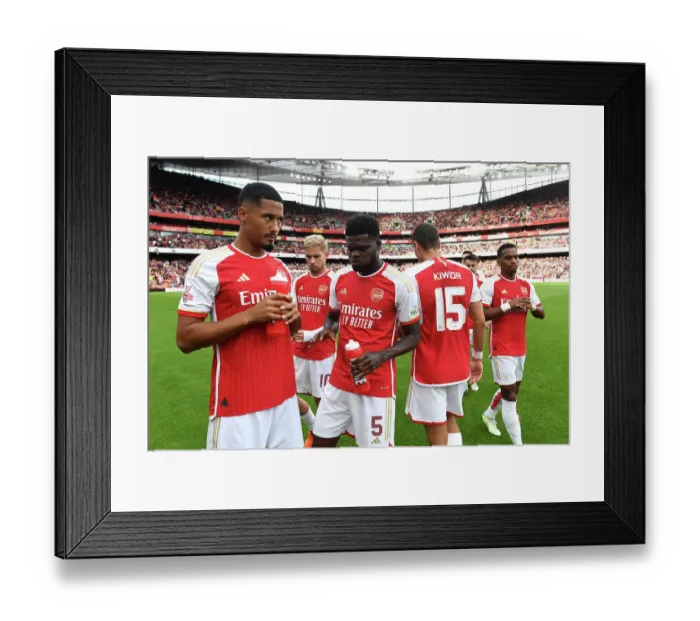 Framed Print : Arsenal's Saliba and Partey Share a Moment Before Arsenal FC vs AS Monaco (2023-24 Emirates Cup)