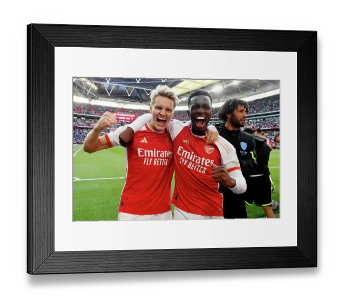 Framed Print : Arsenal Rejoice in Community Shield Triumph: Odegaard and Nketiah's Victory Embrace (2023-24)