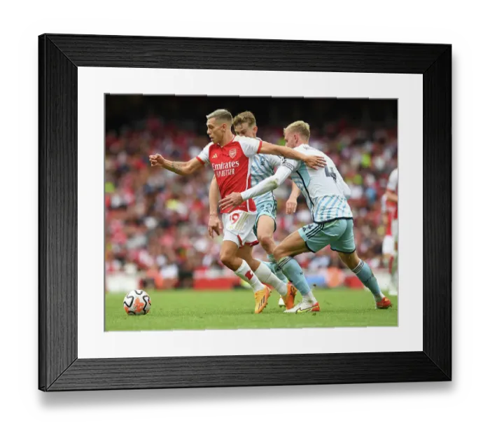 Framed Print : Arsenal vs. Nottingham Forest: Trossard Tangles with Worrall in 2023-24 Premier League Clash