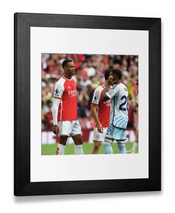 Framed Print : Arsenal's Gabriel Magalhaes and Nottingham Forest's Danilo Share a Moment After 2023-24 Premier League Encounter