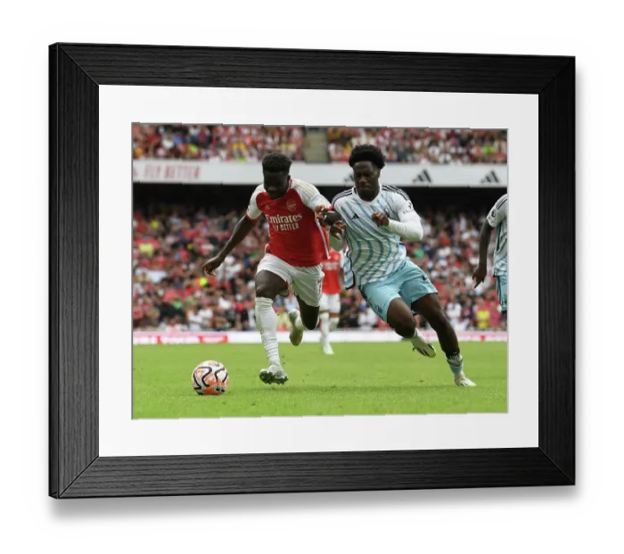 Framed Print : Saka vs. Aina: A Premier League Battle at Emirates Stadium