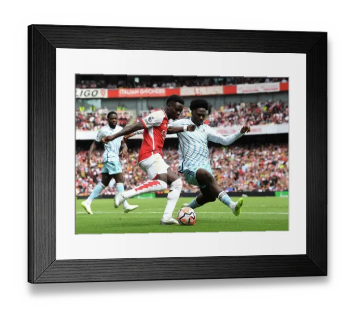 Framed Print : Saka vs. Aina: Intense Battle in Arsenal's 2023-24 Premier League Clash