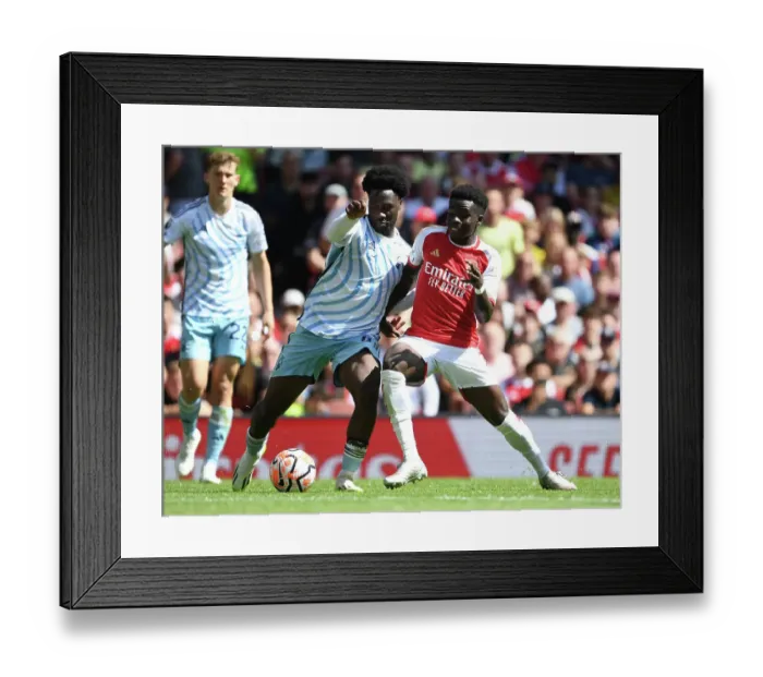 Framed Print : Arsenal's Bukayo Saka Clashes with Nottingham Forest's Ola Aina in 2023-24 Premier League Showdown Framed Print : Arsenal's Bukayo Saka Clashes with Nottingham Forest's Ola Aina in 2023-24 Premier League Showdown