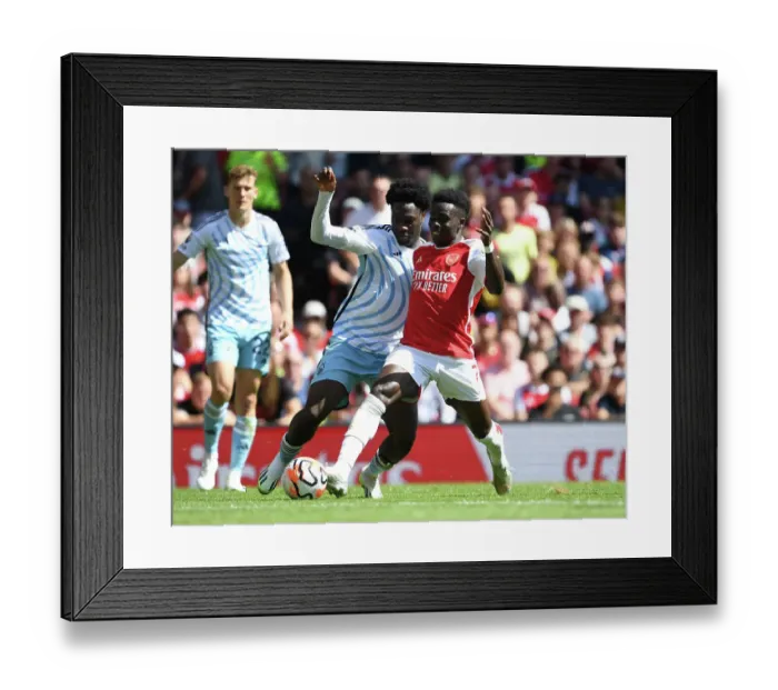 Framed Print : Saka vs. Aina: Clash of Wings in Arsenal's 2023-24 Premier League Battle Framed Print : Saka vs. Aina: Clash of Wings in Arsenal's 2023-24 Premier League Battle