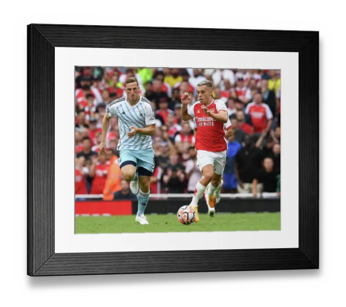 Framed Print : Arsenal's Trossard Outruns Forest's Wood in 2023-24 Premier League Clash Framed Print : Arsenal's Trossard Outruns Forest's Wood in 2023-24 Premier League Clash