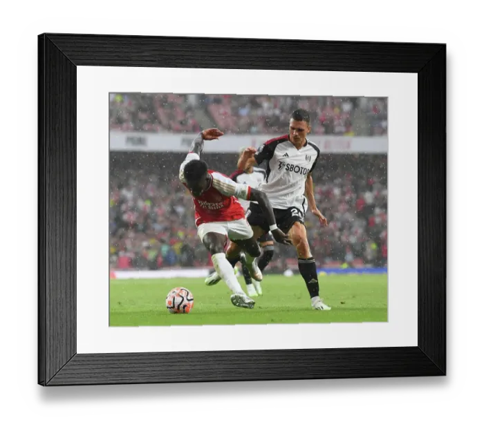 Framed Print : Arsenal's Bukayo Saka Fights for Possession Against Fulham's Joao Palhinha in 2023-24 Premier League Clash