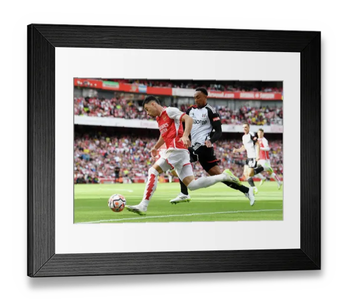 Framed Print : Arsenal's Martinelli Fends Off Fulham's Tete in Premier League Clash (2023-24) Framed Print : Arsenal's Martinelli Fends Off Fulham's Tete in Premier League Clash (2023-24)
