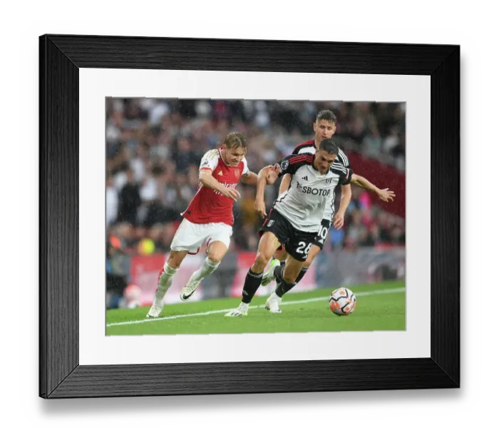 Framed Print : Odegaard vs. Palhinha: A Premier League Battle at Emirates Stadium