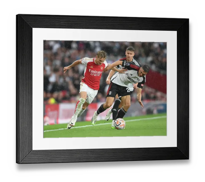 Framed Print : Martin Odegaard vs. Joao Palhinha: A Premier League Battle at Emirates Stadium
