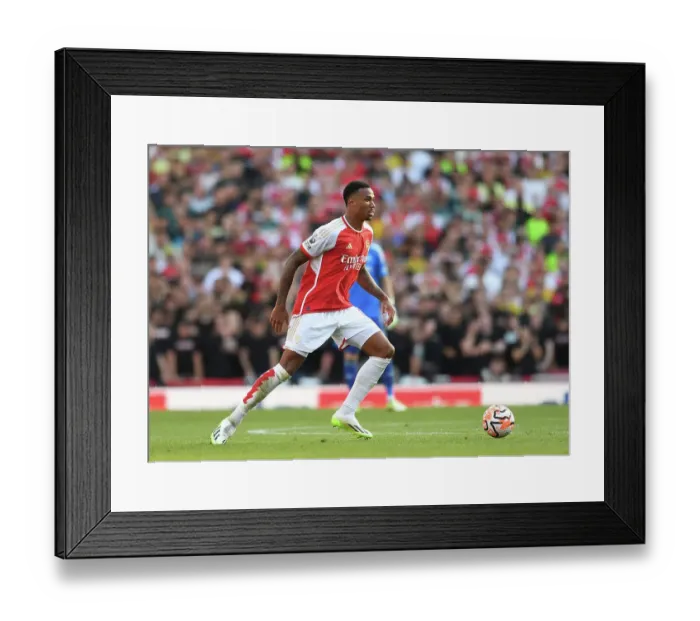 Framed Print : Arsenal's Gabriel Magalhaes Faces Off Against Manchester United in the Premier League (2023-24)
