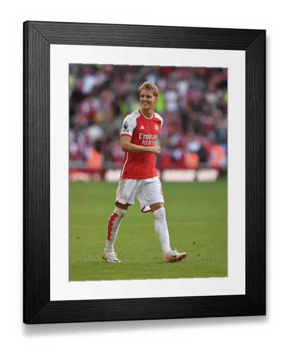 Framed Print : Martin Odegaard's Thrilling Victory Celebration: Arsenal's Triumph Over Manchester United (2023-24 Premier League)