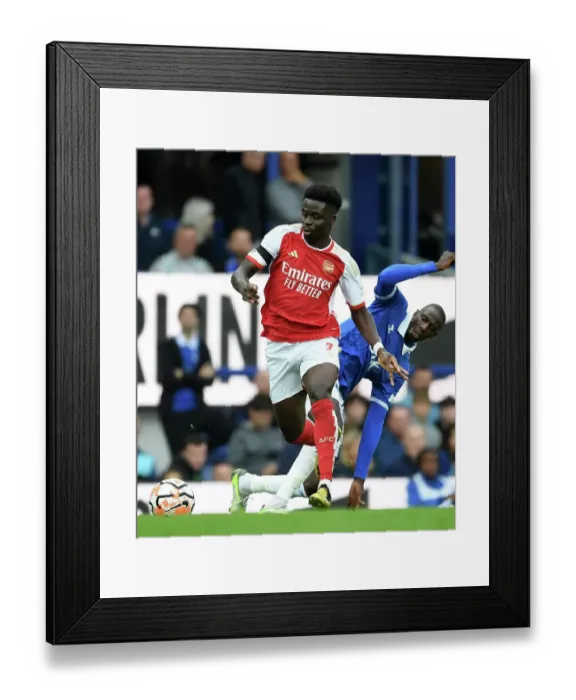 Framed Print : Saka vs Doucoure: Intense Battle at Goodison Park - Everton vs Arsenal, Premier League 2023-24