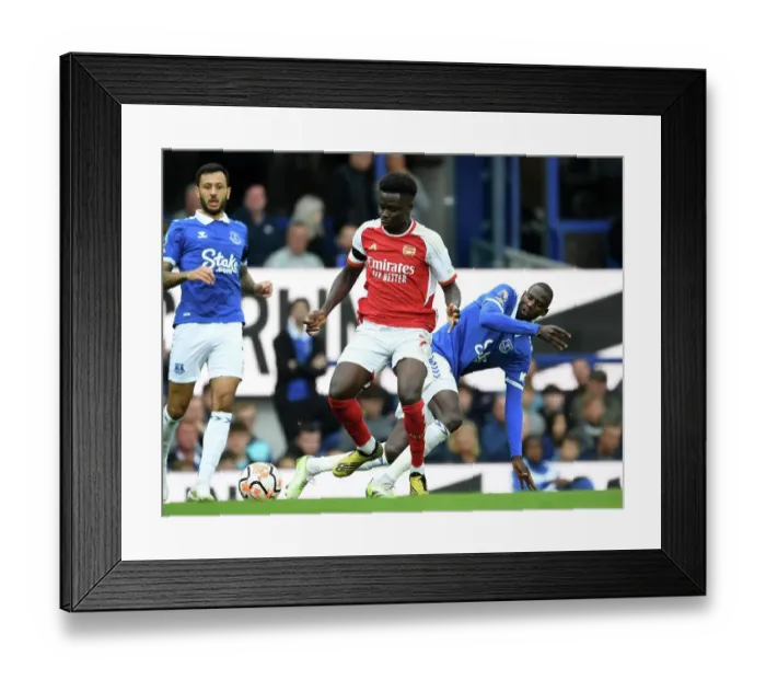 Framed Print : Saka vs Doucoure: A Premier League Battle at Goodison Park Framed Print : Saka vs Doucoure: A Premier League Battle at Goodison Park