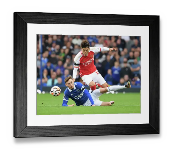 Framed Print : Clash at Goodison Park: Arsenal's Tomiyasu Faces Off Against Everton's Garner (2023-24)