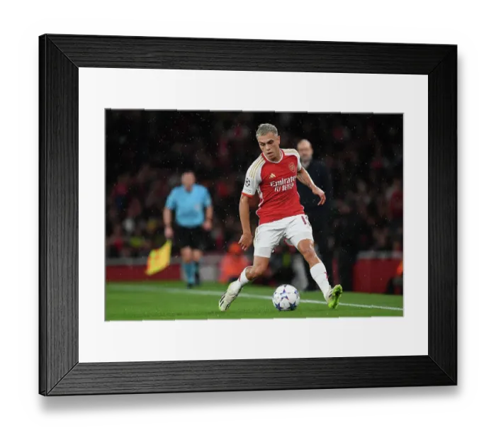 Framed Print : Champions League Thriller: Trossard's Epic Dash at Arsenal's Emirates Stadium