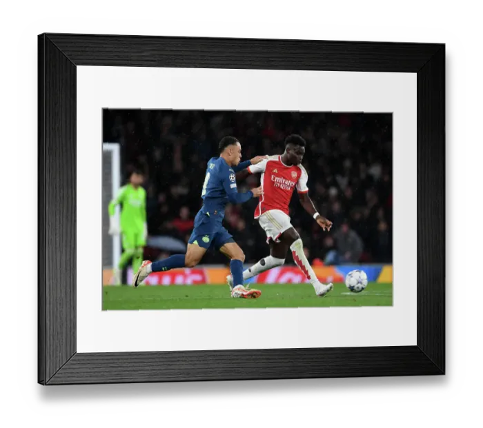 Framed Print : Battling Wings: Saka vs. Dest in Arsenal's Champions League Clash Framed Print : Battling Wings: Saka vs. Dest in Arsenal's Champions League Clash