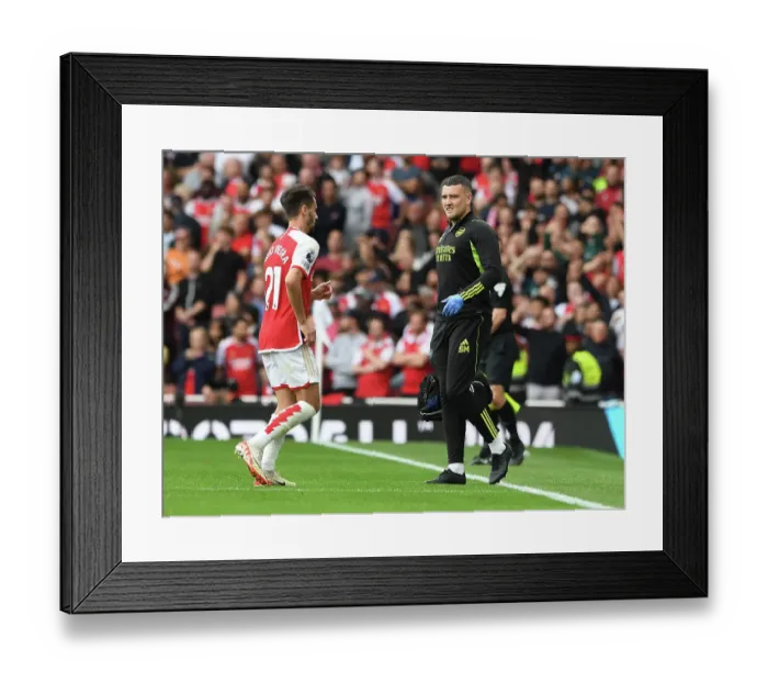 Framed Print : Arsenal Physio Simon Murphy Attends to Injured Player Amidst Intense Arsenal vs. Tottenham Clash (2023-24)