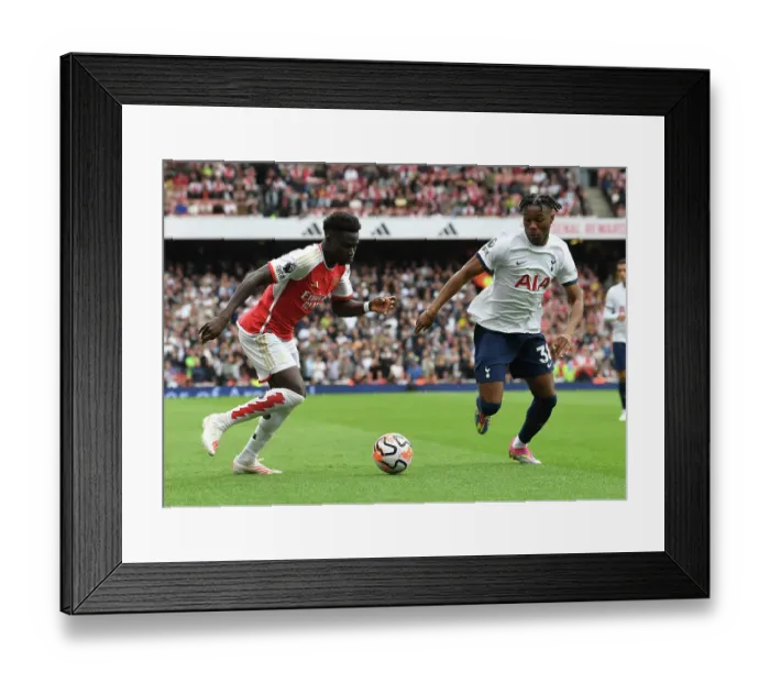 Framed Print : Arsenal's Bukayo Saka Clashes with Tottenham's Destiny Udogie in the 2023-24 Premier League Showdown at Emirates Stadium Framed Print : Arsenal's Bukayo Saka Clashes with Tottenham's Destiny Udogie in the 2023-24 Premier League Showdown at Emirates Stadium