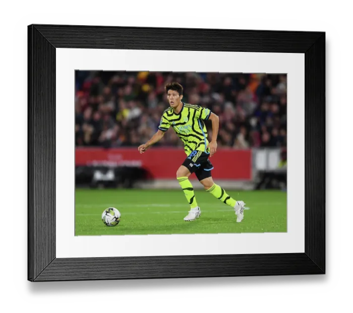 Framed Print : Arsenal's Tomiyasu Charges Forward in Carabao Cup Clash Against Brentford
