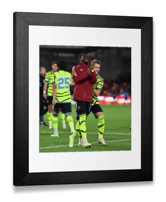 Framed Print : Emotional Reunion: Martin Odegaard and Charles Sagoe Jr after Arsenal's Carabao Cup Victory at Brentford