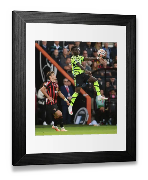 Framed Print : Saka Soars: Arsenal's Bukayo Outjumps Bournemouth's Kerkez in Premier League Clash (AFC Bournemouth vs Arsenal 2023-24)