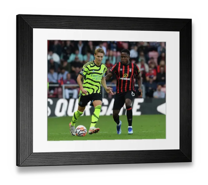 Framed Print : Arsenal's Martin Odegaard Faces Pressure from Bournemouth's Luis Sinisterra in Premier League Clash (AFC Bournemouth vs Arsenal 2023-24)
