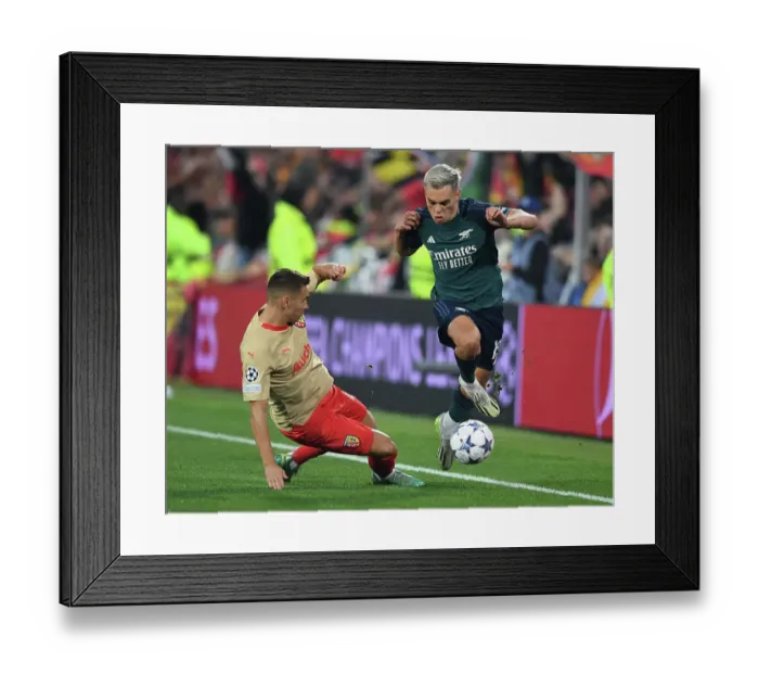 Framed Print : Arsenal's Trossard Outmaneuvers RC Lens Frankowski in Champions League Clash Framed Print : Arsenal's Trossard Outmaneuvers RC Lens Frankowski in Champions League Clash